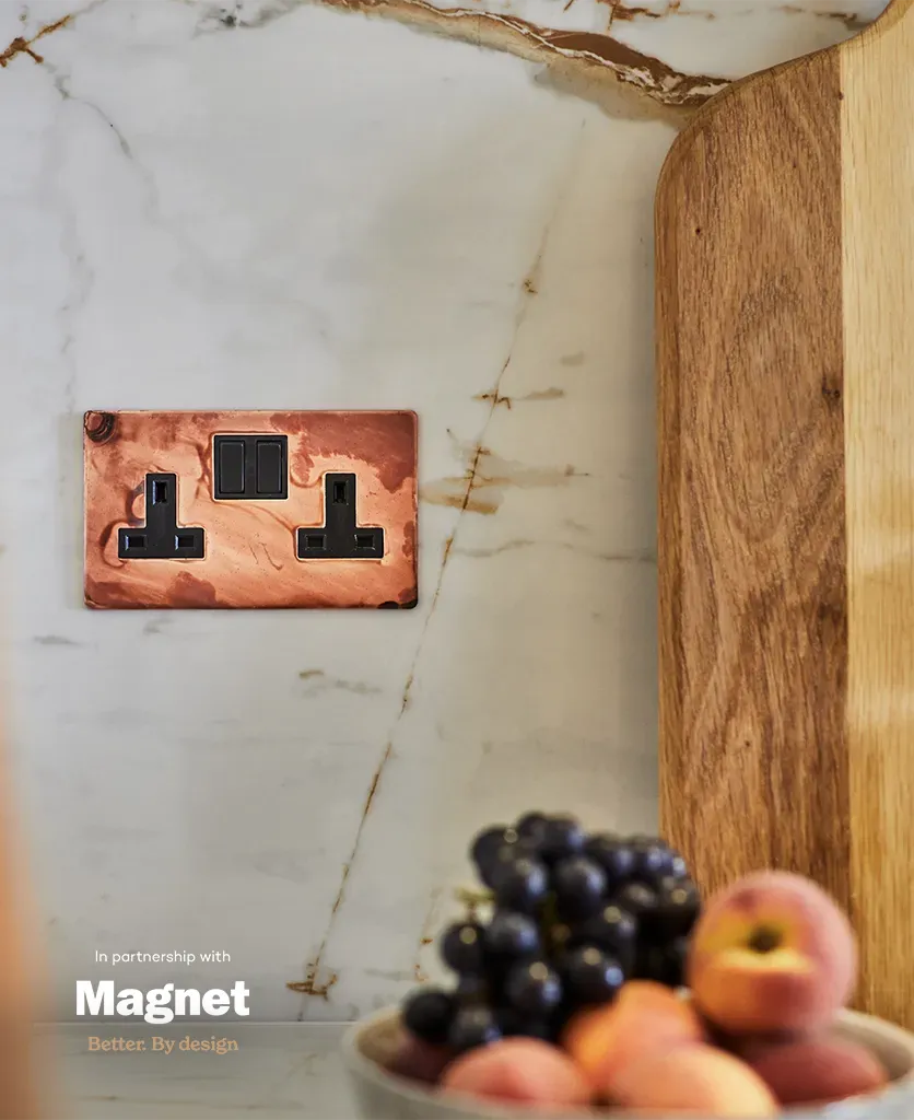 tarnished copper double socket adds a glamorous metallic touch to the kitchen