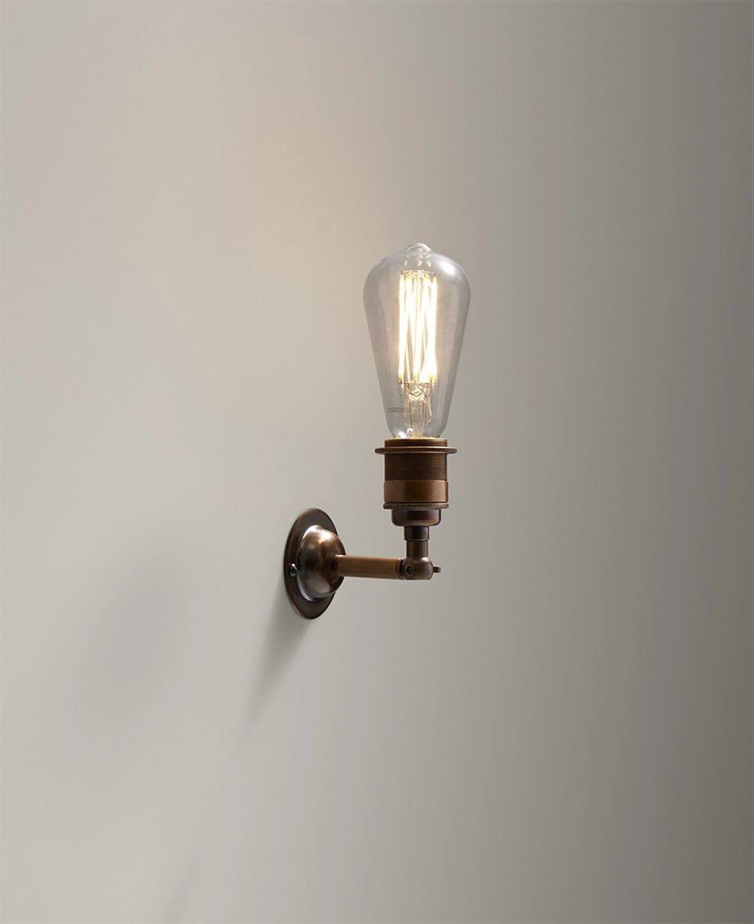 heritage style wall light in aged bronze finish with filament light bulb